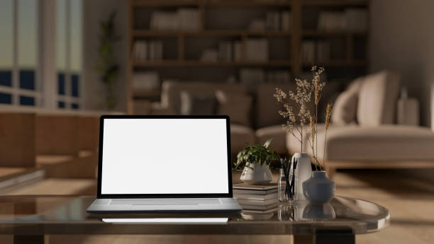 istock A laptop computer with a white-screen mockup on a modern coffee table in a contemporary living room. 2162187705