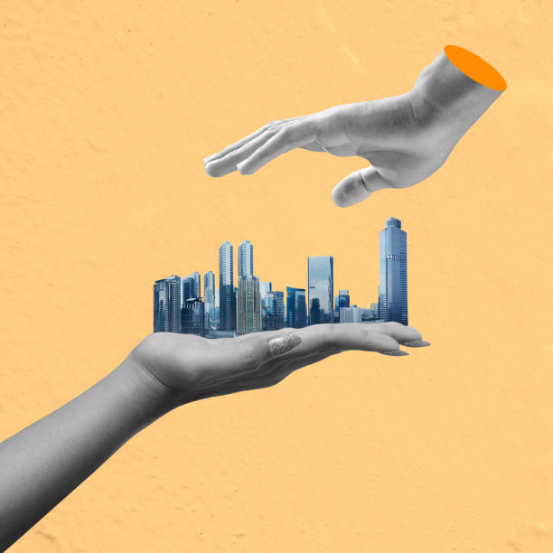 Human hand showing modern buildings and skyscrapers