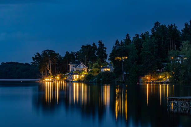 Stockholm, Sweden A night view of illuminated houses on an island in Lake Malaren.