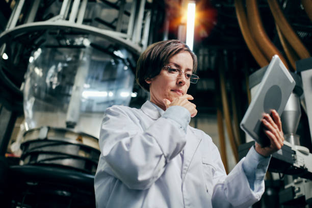 istock Thoughtful female engineer with tablet working at the factory 2162194681