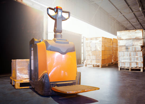 istock Electric Forklift Pallet Jack Loads Package Boxes into Container Truck. Forklift Loader. Warehouse Shipping. Supply Chain, Shipment, Freight Truck Logistics, Cargo Transport. 2162197616