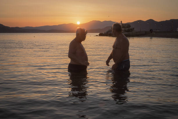 istock Cooling off at the sea, two friends are swimming 2162198708