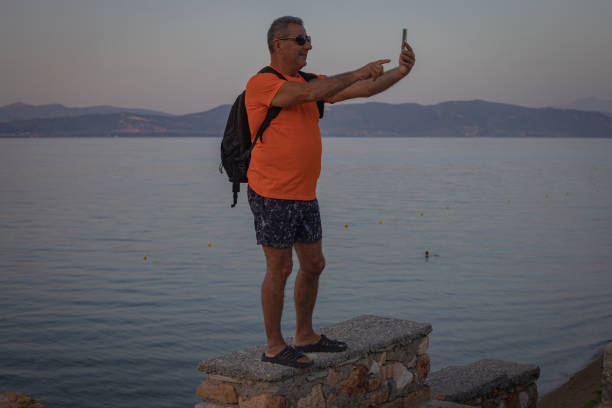 istock Tourist walk along the sea coast 2162199183