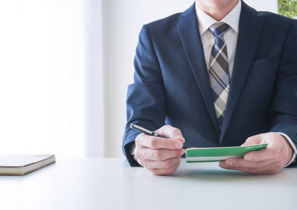 istock businessman looking at bank passbook 2162200835