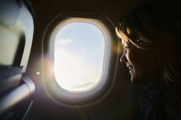 istock Young happy woman traveling by plane. 2162201811