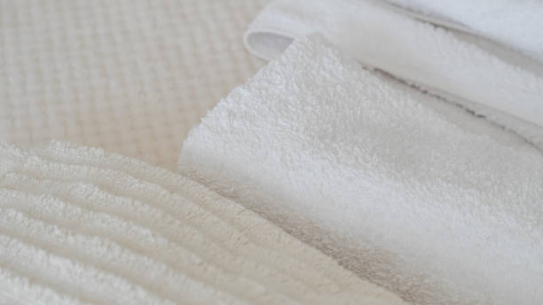 istock White and beige towels neatly stacked, adding a touch of elegance and comfort 2162201978