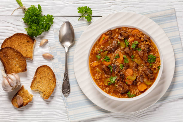 istock beef barley soup in a bowl, top view 2162202090