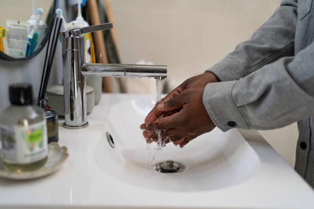 istock Young man washing hands in bathroom at home 2162202598