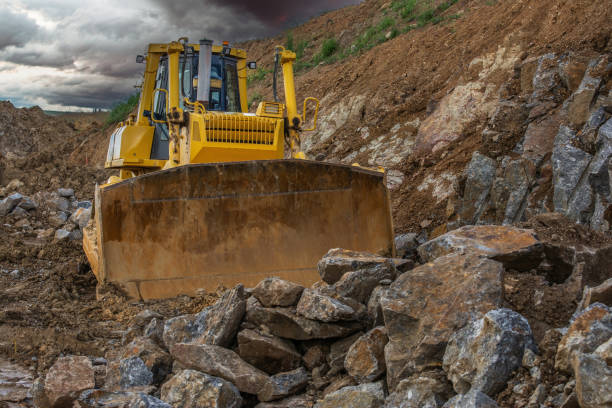 istock Excavator making earth movements for the construction of a road 2162203869