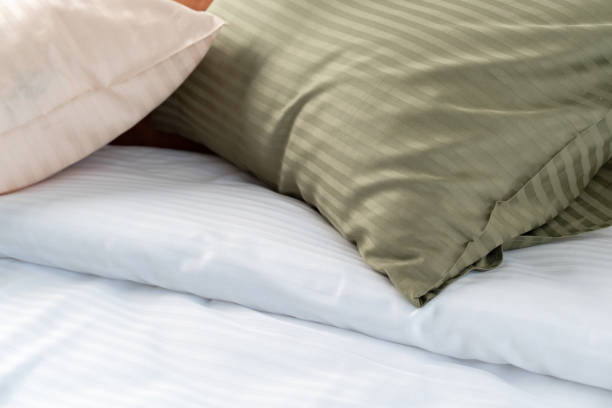 istock Striped Pillows on a Bed With Black Metal Headboard 2162204695