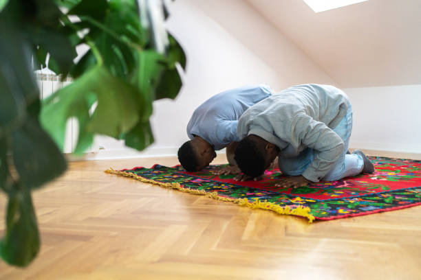 istock Two Muslim friends praying at home 2162204838
