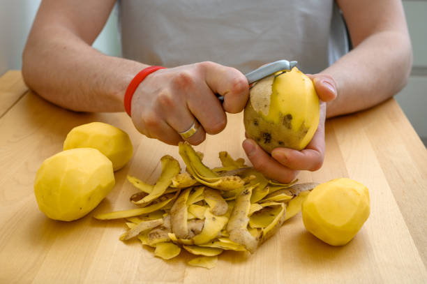 istock Peel the potatoes with a peeler close up, kitchen aid 2162206346