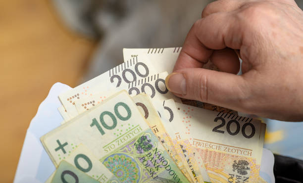 istock A retired elderly lady counts her savings, pln cash 2162206551