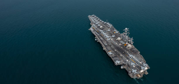 istock Aerial view military nuclear ship navy ship carrier full loading fighter jet aircraft, Aircraft carrier nuclear warship battleship, Military nuclear ship on the ocean. 2162211139