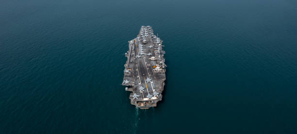 istock Aerial view military nuclear ship navy ship carrier full loading fighter jet aircraft, Aircraft carrier nuclear warship battleship, Military nuclear ship on the ocean. 2162211141