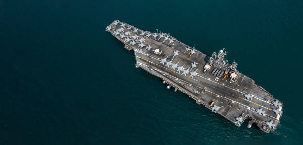 istock Aerial view military nuclear ship navy ship carrier full loading fighter jet aircraft, Aircraft carrier nuclear warship battleship, Military nuclear ship on the ocean. 2162211144