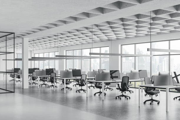 istock Stylish coworking interior with pc desktop on tables in row, panoramic window 2162212626