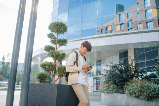istock Korean Student's Joyful Outdoor Internet Connection 2162212656