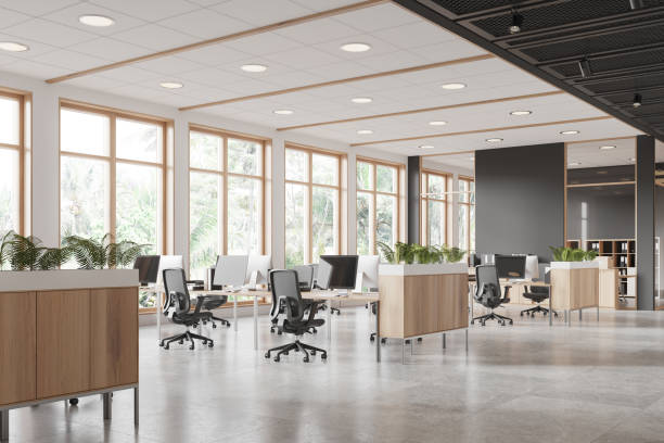 istock Stylish coworking interior with pc monitors and chairs near panoramic window 2162212727