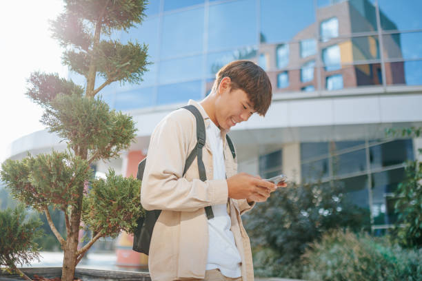 istock Young Man Smiling in a Mobile Phone Dialogue 2162212758