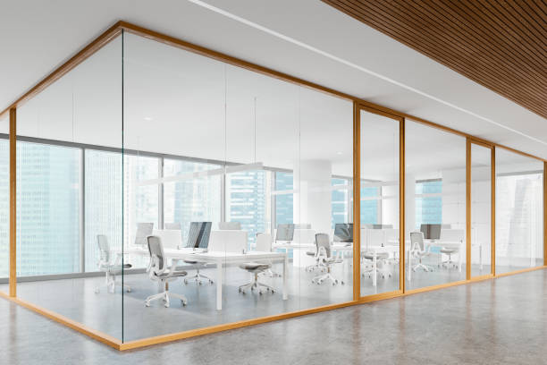 istock Glass office coworking interior with desk, pc monitors and panoramic window 2162213782