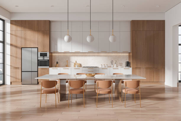 istock Home kitchen interior with eating table and chairs, cooking cabinet and window 2162214044