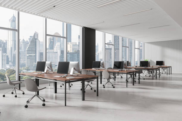 istock Cozy office coworking interior with table and pc desktops, panoramic window 2162214141