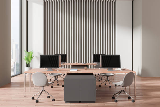 istock Modern office space with desks and computers, minimalist design, wooden floor, bright environment. 3D Rendering 2162214886