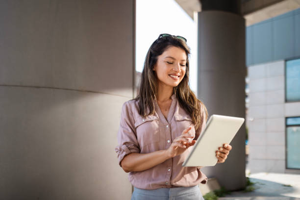 istock Businesswoman with Tablet Outside Office 2162215367