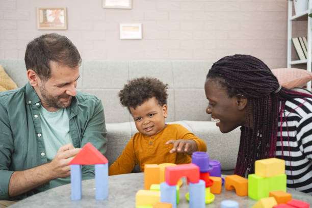 istock Mixed-race couple plays with their son with blocks 2162215383