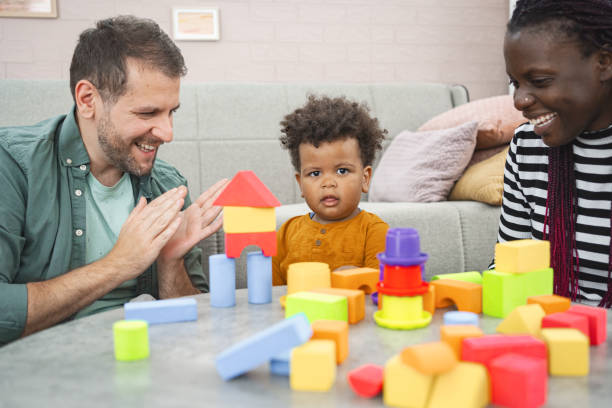 istock Mixed-race couple plays with their son with blocks 2162215420