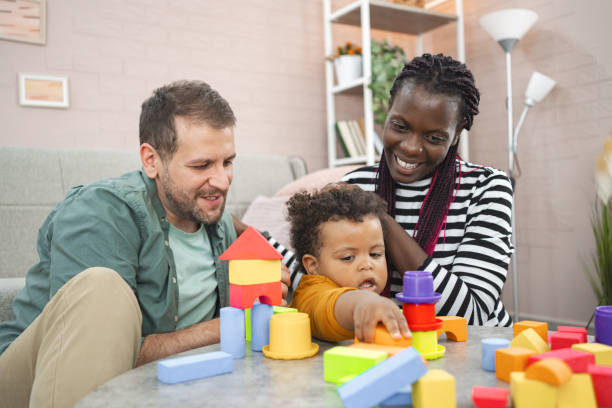 istock Mixed-race couple plays with their son with blocks 2162215426