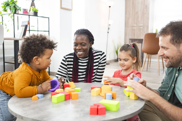 istock Mixed family with two children plays with blocks 2162215502