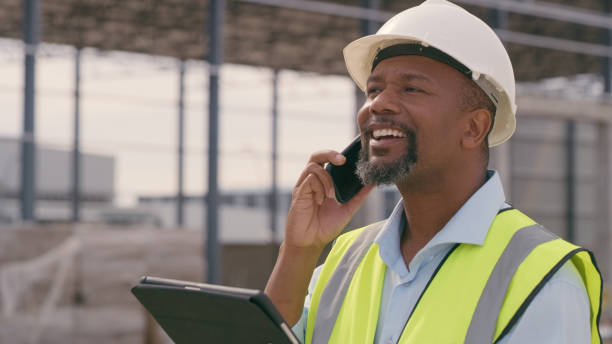 istock Man, construction and tablet with phone call at site for project management or building logistics. Male person and engineering worker talking on technology at industrial architecture design 2162218541