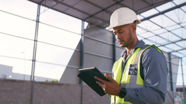 istock Man, construction and tablet at site for project management, building logistics or app. Male person and engineering worker on digital technology at industrial architecture design 2162218544