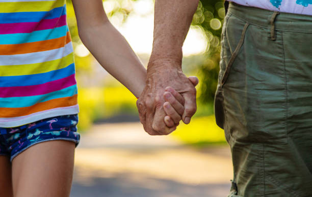 istock Child with grandmother holding hand. Selective focus. 2162219453