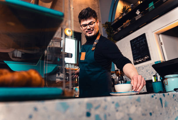 istock Barista working behind the counter in the cafe, getting ready to make coffee. 2162221014