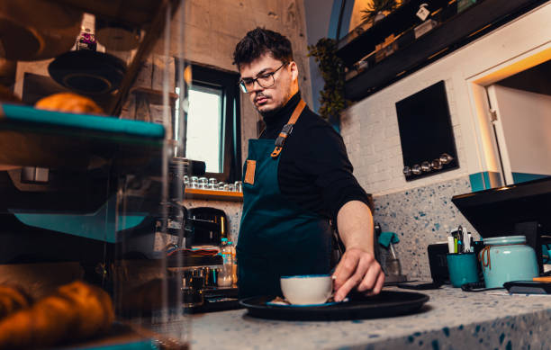 istock Barista working behind the counter in the cafe, getting ready to make coffee. 2162221026
