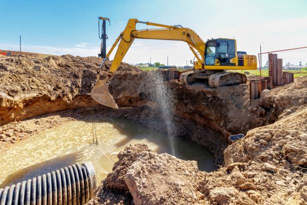 istock Excavator at a Construction Site Digging a Large Trench 2162221547