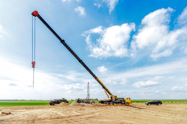 istock A construction site with a lifting crane and workers installing water pipes. 2162221581