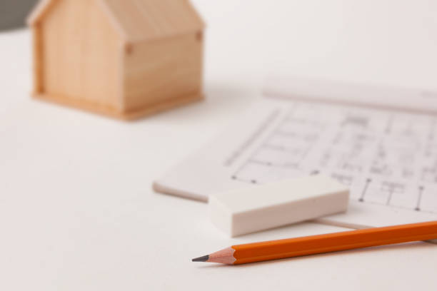 istock A pencil and a house model placed on a table, representing architectural design and planning. 2162222767