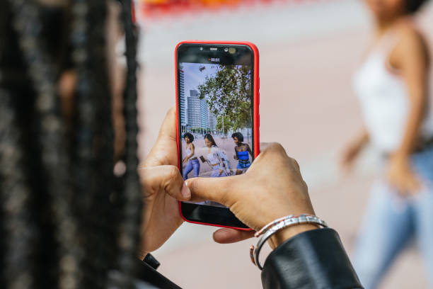 istock Mobile screen while women recording a video dancing in the street 2162222785