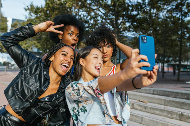 istock Diverse friends gesturing success while taking a funny selfie together 2162223352