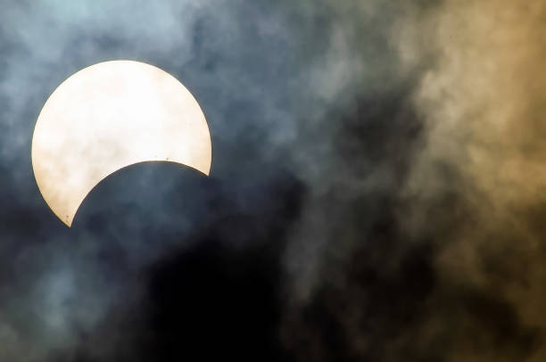 istock A large white sun is seen in the sky behind a dark cloud 2162223718