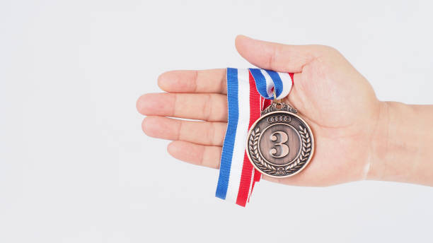 istock Hand is hold bronze medal on white background. 2162224600