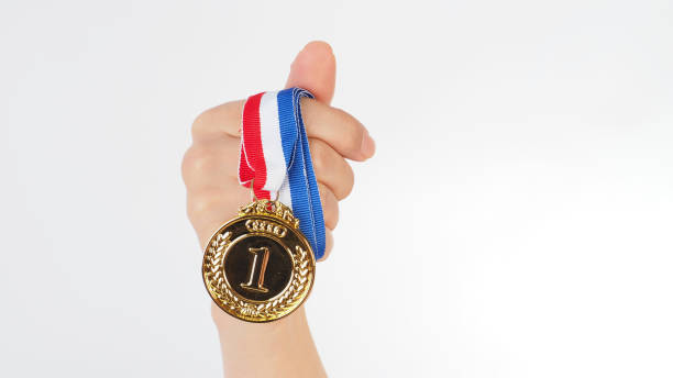 istock Hand is hold gold medal on white background. 2162225129