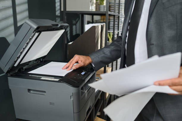 istock Lawyer putting paper on copier screen 2162225653