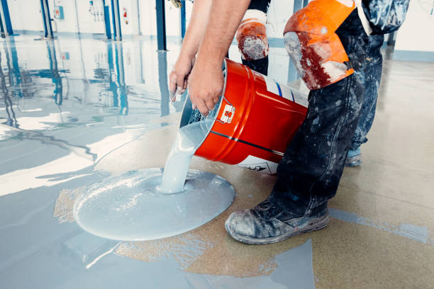 istock Construction workers pouring epoxy resin on concrete floor 2162227537
