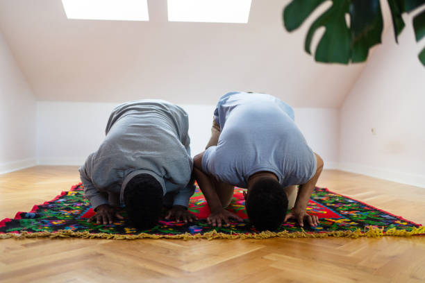 istock Two Muslim men praying at home 2162227916