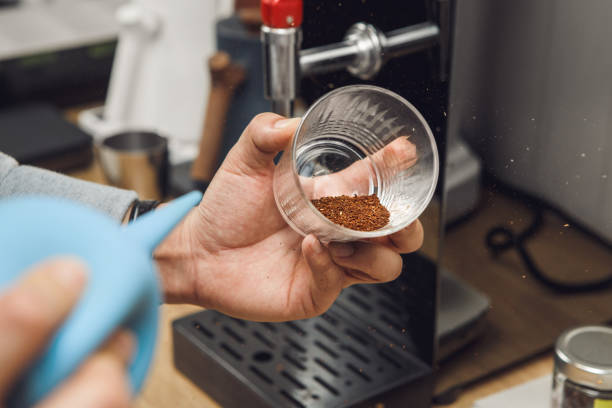 istock Barista Cleans Ground Coffee from Excess Husks and Particles using an Air 2162229277